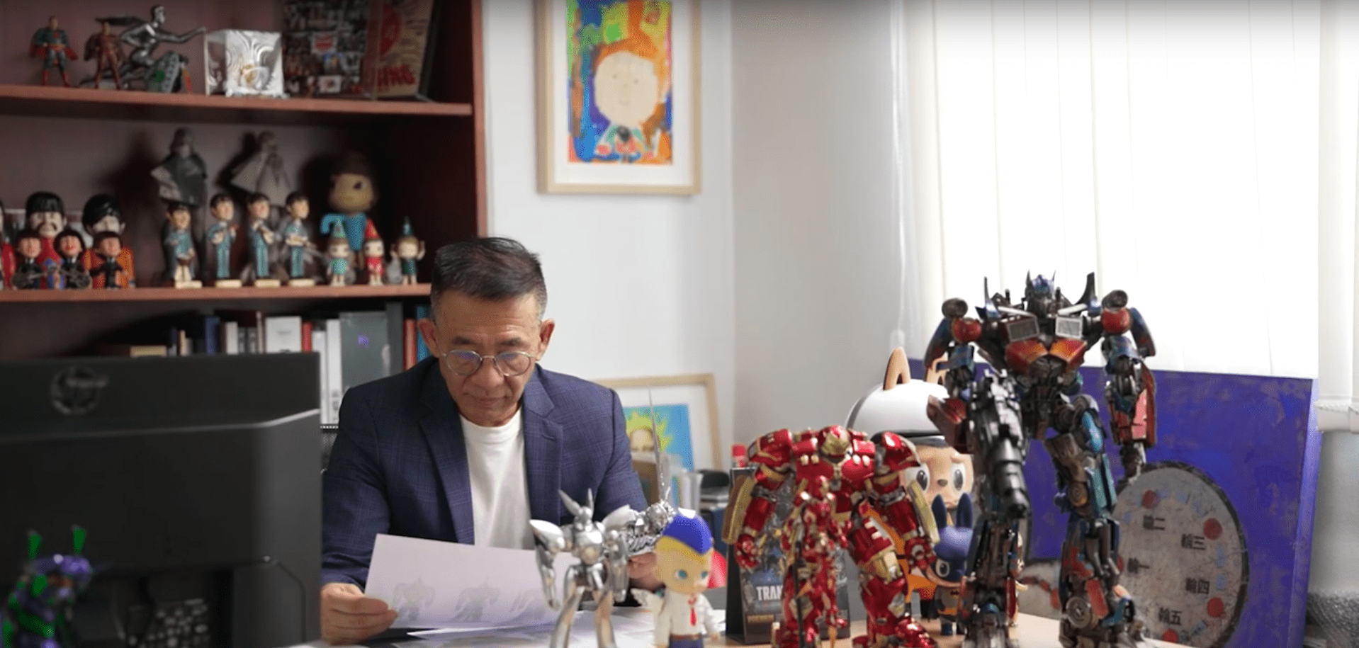 The Founder & Chairman of threezero is sitting in the office and reading.