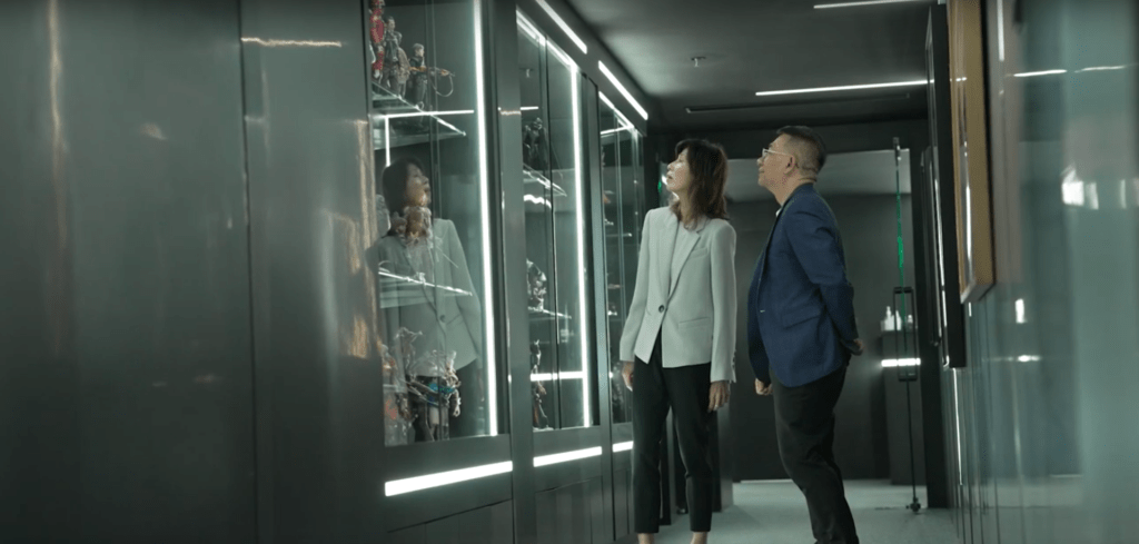 Two people looking at the display shelves in the room.