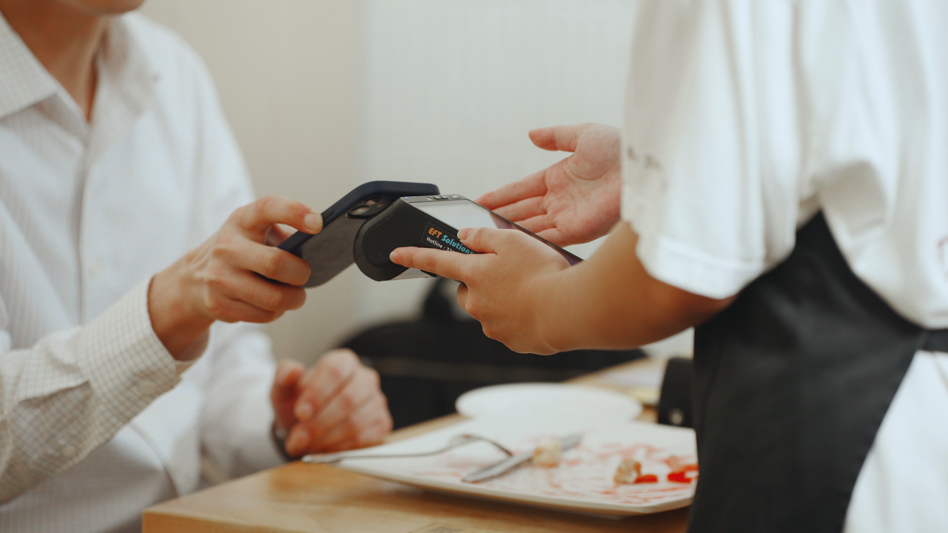 A customer paying his bill at Nun Dessert Café